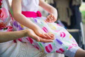Close-up,Mother's,Hand,And,Daughter's,Disabled,Hand,Outdoors